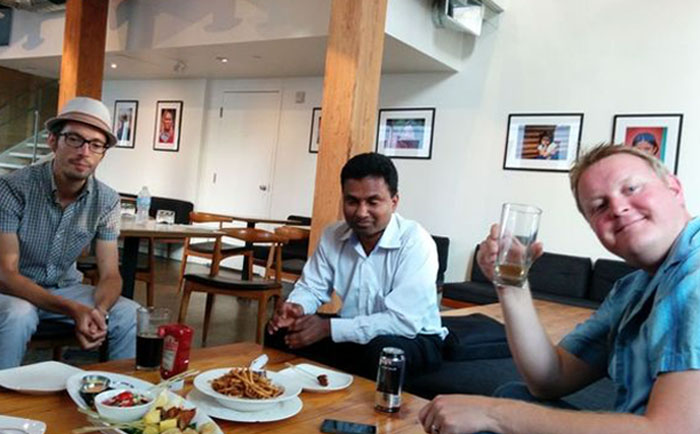 friends sharing a drink and a meal after a presentation